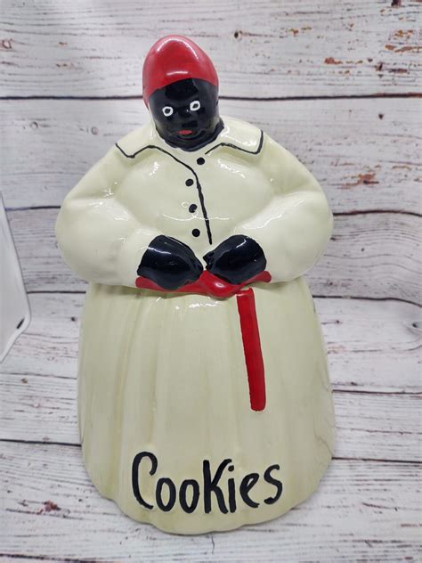 Old milk-can-shaped cookie jars with molded handles in black, blue, ivory, yellow. . Mccoy mammy cookie jar history